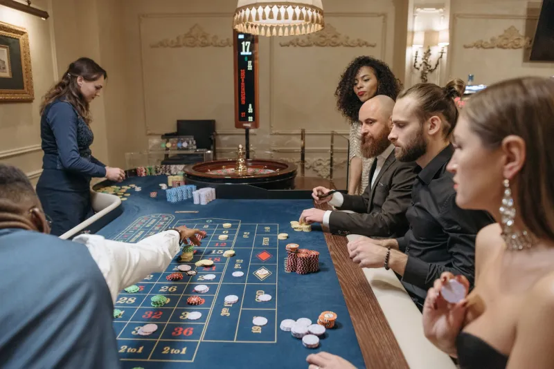 Mates, Rounds, and Raised Stakes: The Hidden Cost of Gambling in a Group